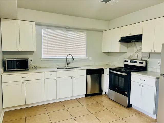 a view of a kitchen with a sink and a window