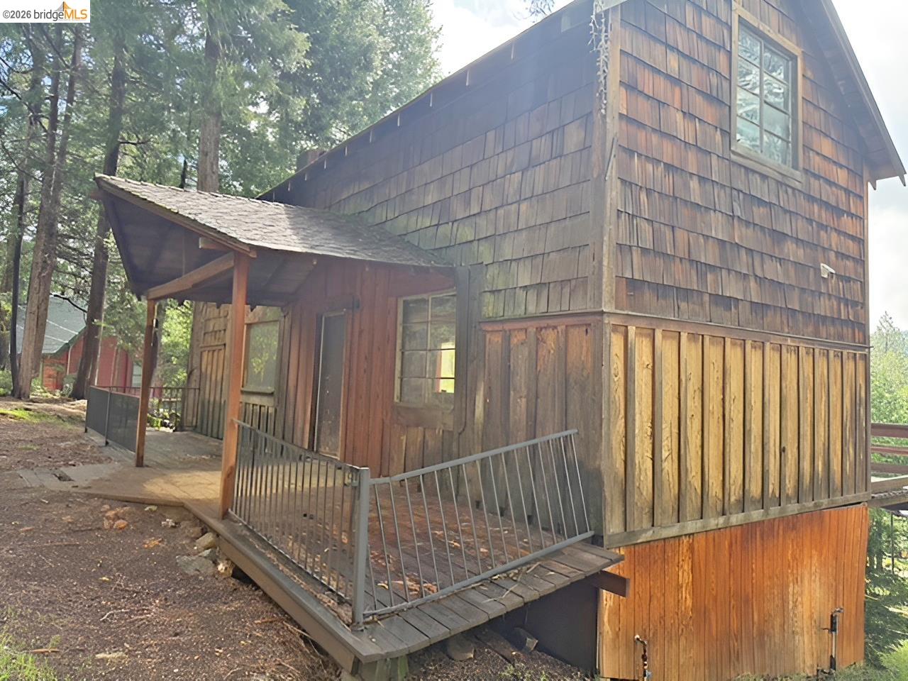 20693 Muheli Road Mi Wuk Village, CA 95346 - Photo 4 of 15 a view of a porch with wooden floor and iron fence