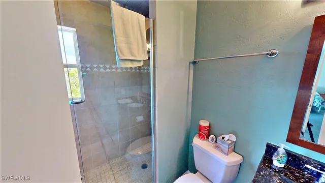 a bathroom with a toilet and shower