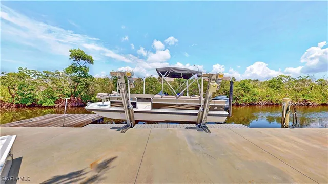 a view of a patio with a table and chairs under an umbrella