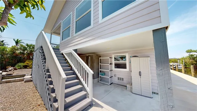 a view of a roof deck with table and chairs and potted plants