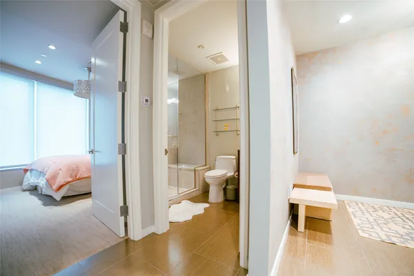 a view of a bedroom and bathroom