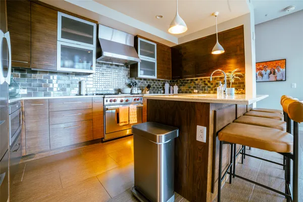 a kitchen with stainless steel appliances granite countertop a sink counter space and cabinets