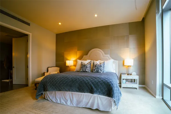 a bedroom with a bed and a painting on the wall