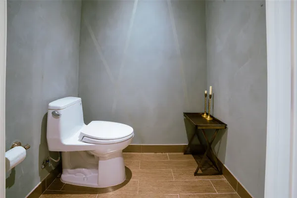 a white toilet sitting next to a sink