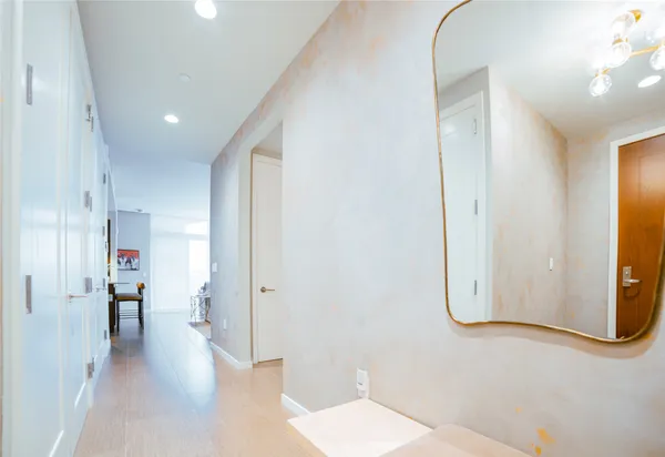 a view of a room with wooden floor and windows