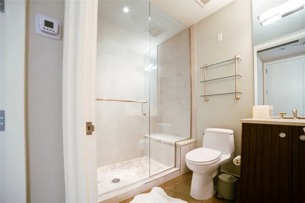 a bathroom with a toilet and a shower