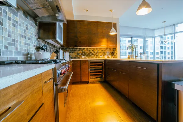 a kitchen with stainless steel appliances granite countertop a sink and cabinets