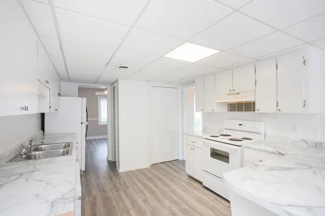 a kitchen with stainless steel appliances a stove a sink and a refrigerator