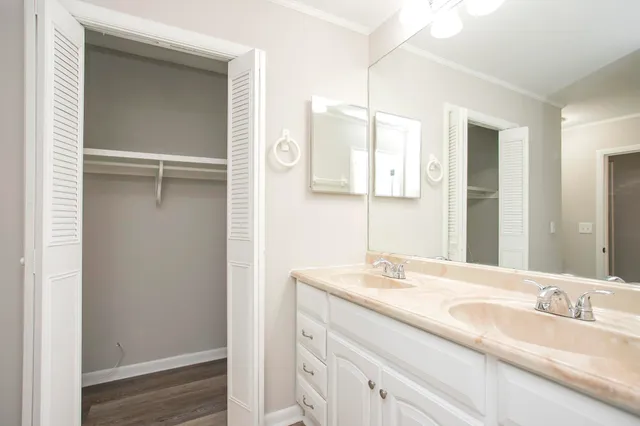 a bathroom with a double vanity sink and mirror