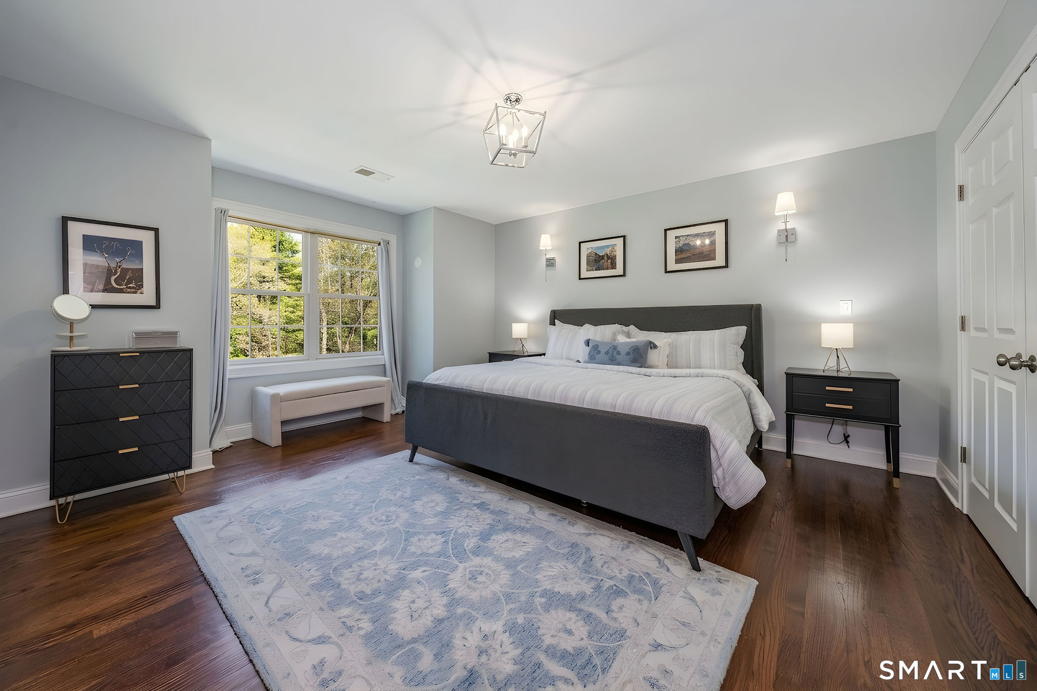 9 Sunset Ridge Drive Guilford, CT 06437 - Photo 18 of 40 a spacious bedroom with a bed and a table in it