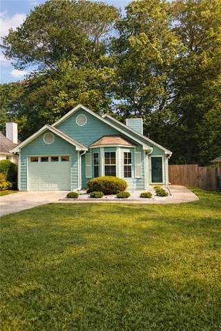 a front view of house with yard and green space