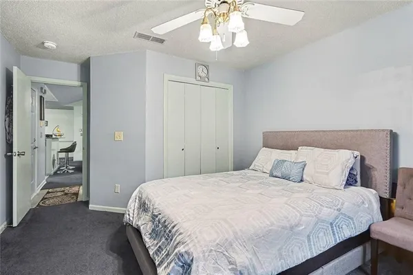 a bedroom with a large bed and a chandelier