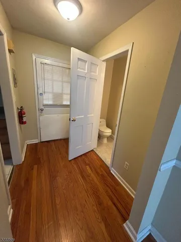 a room with wooden floor and utility room