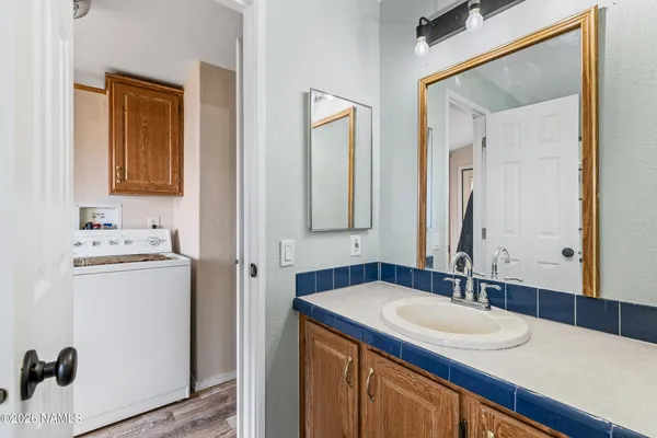 a bathroom with a bathtub and next to a window