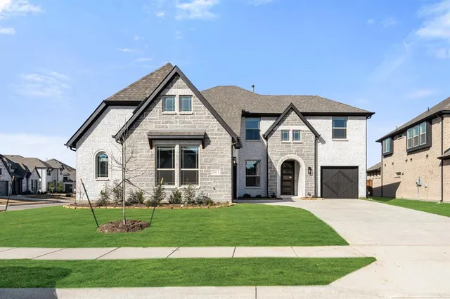 a front view of a house with a garden and plants