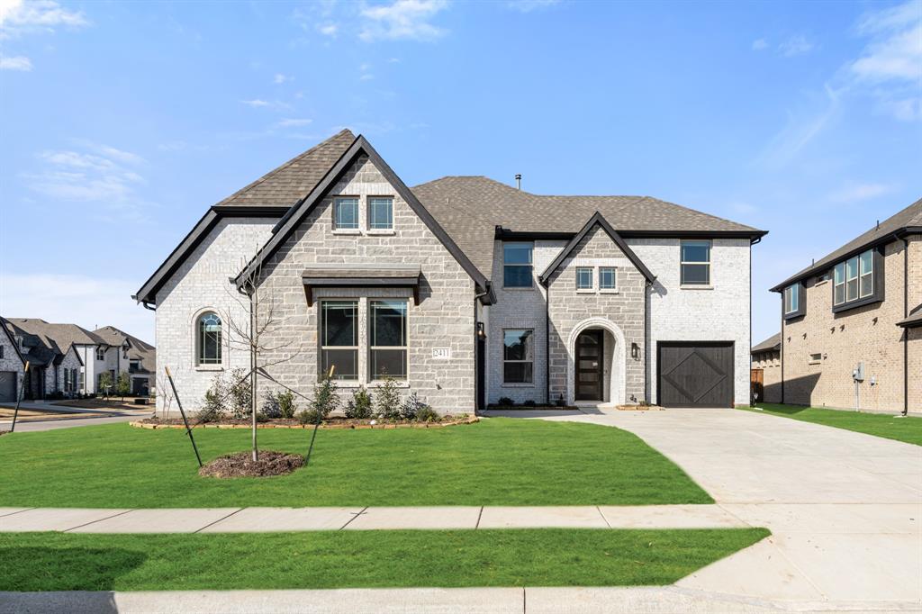 a front view of a house with a garden and plants