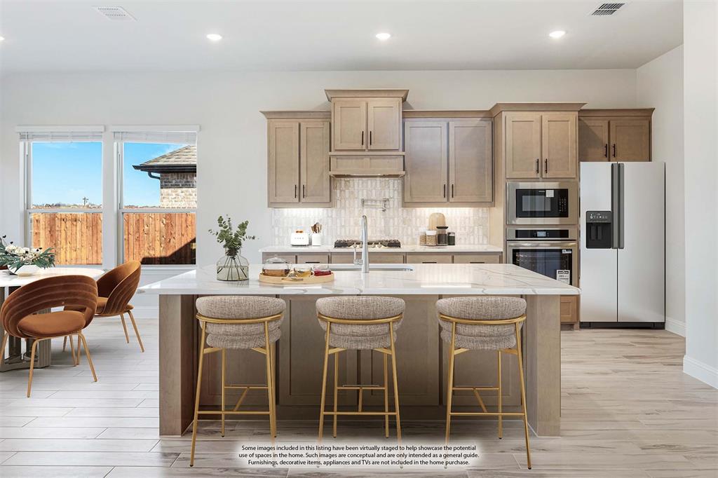 2411 Cornwall Lane Forney, TX 75126 - Photo 12 of 40 a kitchen with stainless steel appliances granite countertop a stove a sink a refrigerator and chairs