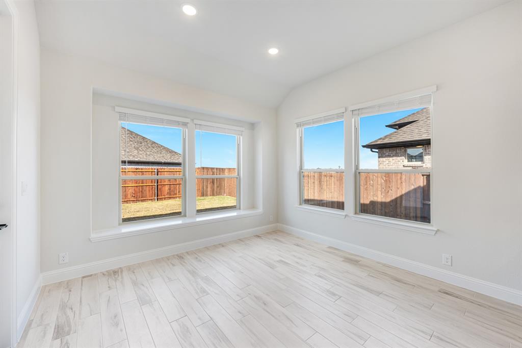 2411 Cornwall Lane Forney, TX 75126 - Photo 15 of 40 an empty room with wooden floor and windows