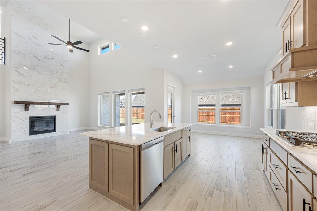 2411 Cornwall Lane Forney, TX 75126 - Photo 17 of 40 a kitchen with stainless steel appliances granite countertop a stove and a wooden floors