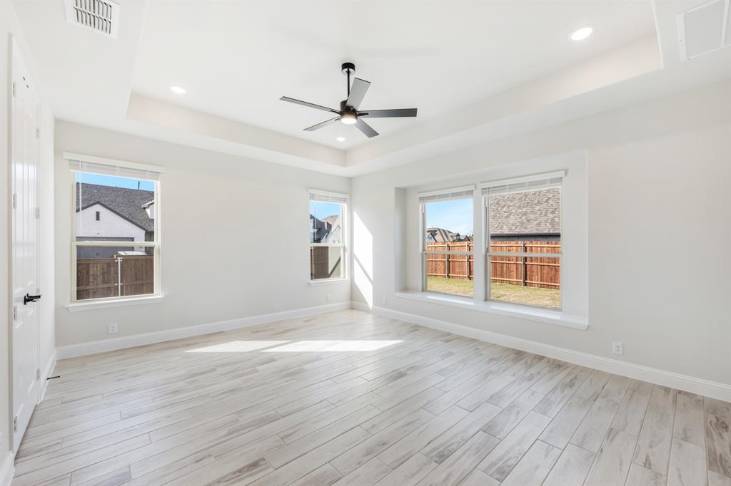 2411 Cornwall Lane Forney, TX 75126 - Photo 19 of 40 a view of an empty room with wooden floor and a window