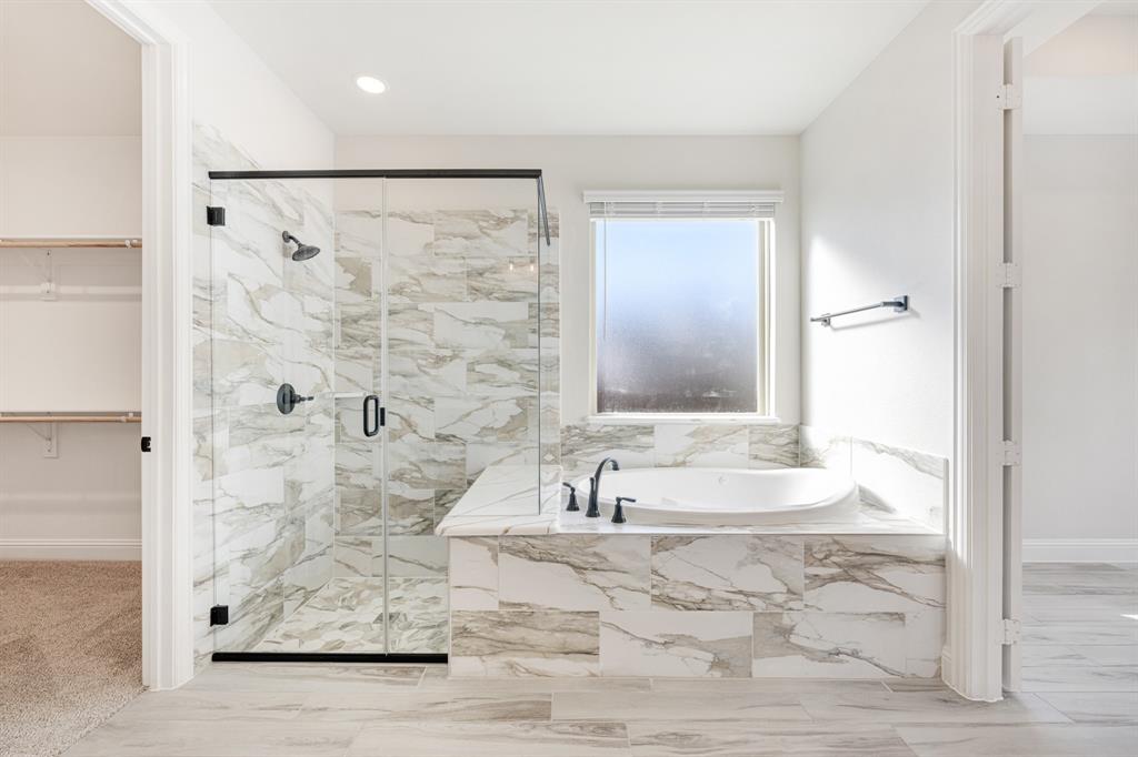 2411 Cornwall Lane Forney, TX 75126 - Photo 21 of 40 a bathroom with a bathtub and a shower