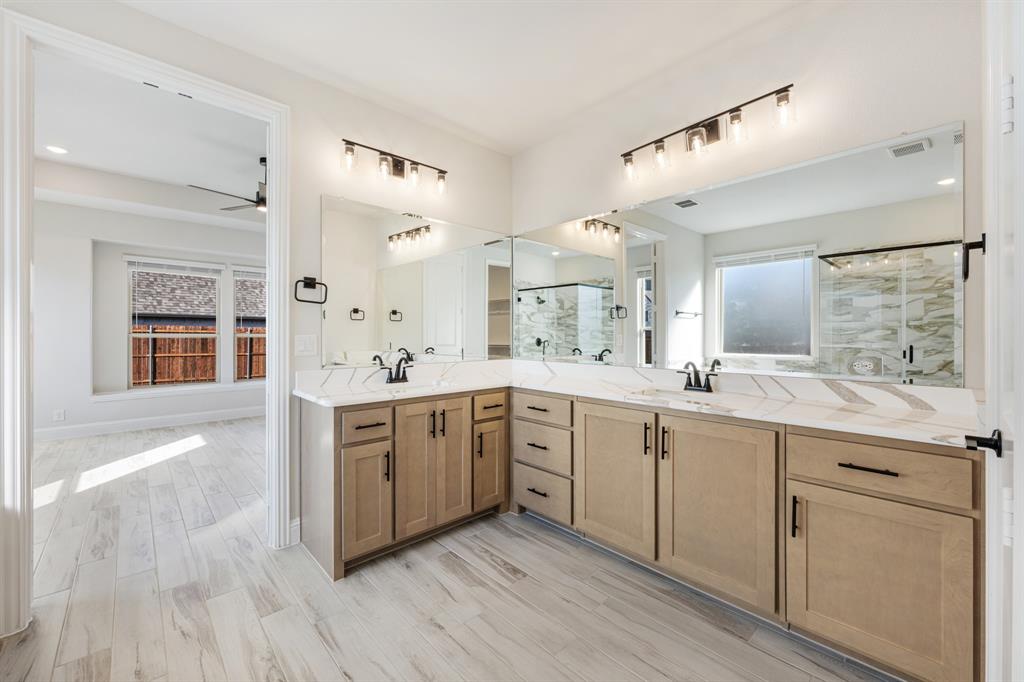 2411 Cornwall Lane Forney, TX 75126 - Photo 22 of 40 a large kitchen with a lot of counter space and wooden floor