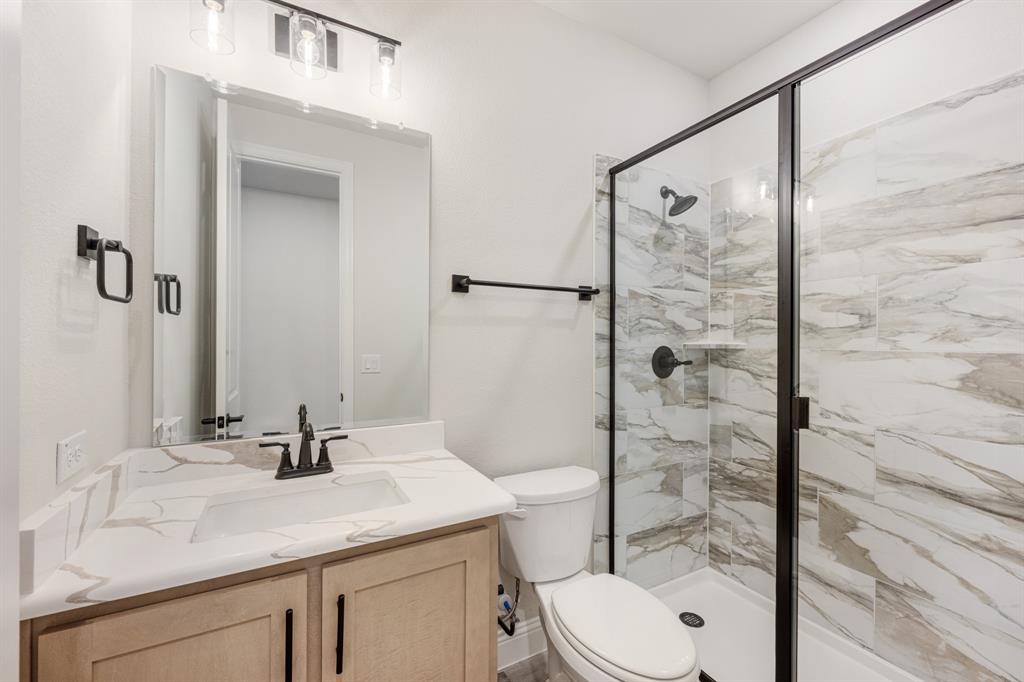 2411 Cornwall Lane Forney, TX 75126 - Photo 26 of 40 a bathroom with a sink toilet and shower