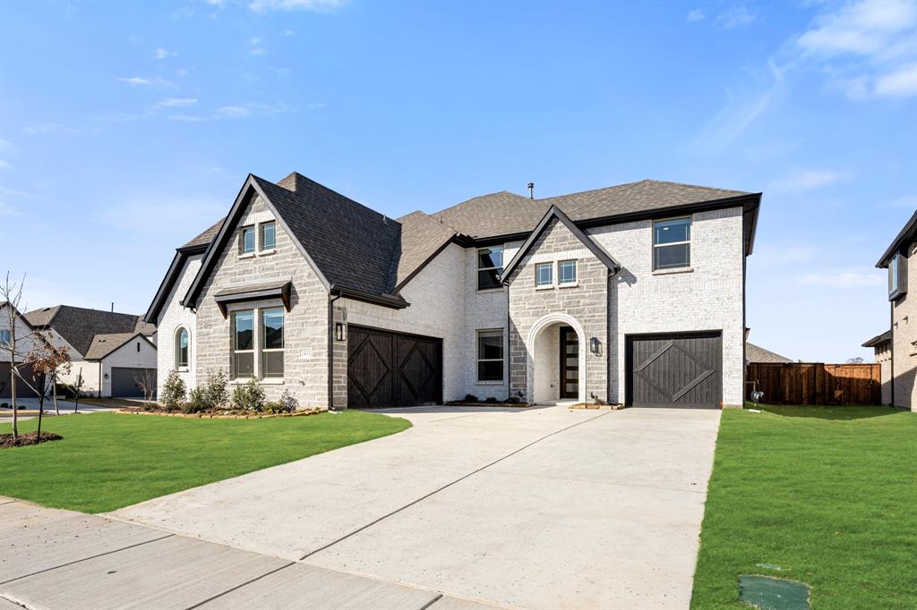 2411 Cornwall Lane Forney, TX 75126 - Photo 3 of 40 a front view of a house with a yard