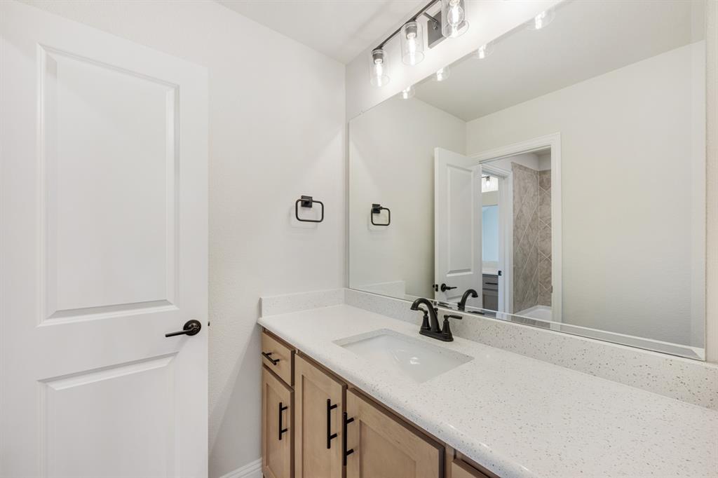 2411 Cornwall Lane Forney, TX 75126 - Photo 33 of 40 a bathroom with a sink and a mirror