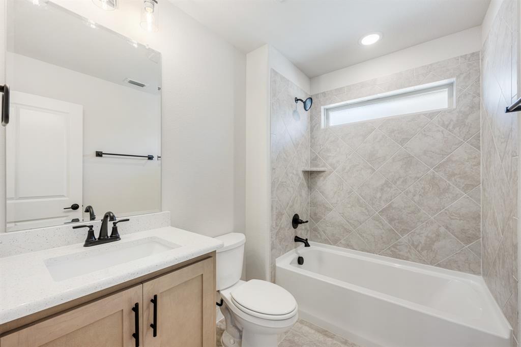 2411 Cornwall Lane Forney, TX 75126 - Photo 36 of 40 a bathroom with a sink a toilet and shower