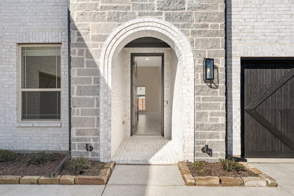 2411 Cornwall Lane Forney, TX 75126 - Photo 4 of 40 a view of a brick house with large windows