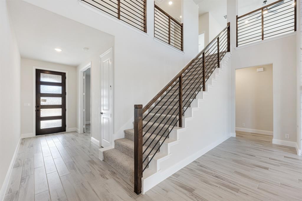2411 Cornwall Lane Forney, TX 75126 - Photo 5 of 40 a view of entryway with wooden floor and stairs