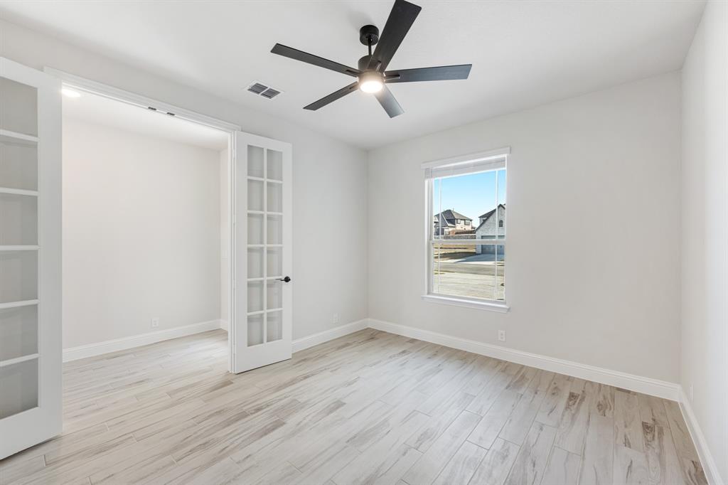 2411 Cornwall Lane Forney, TX 75126 - Photo 6 of 40 wooden floor in an empty room with a window