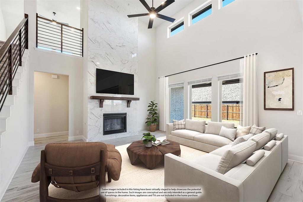 2411 Cornwall Lane Forney, TX 75126 - Photo 9 of 40 a living room with furniture a fireplace and a flat screen tv