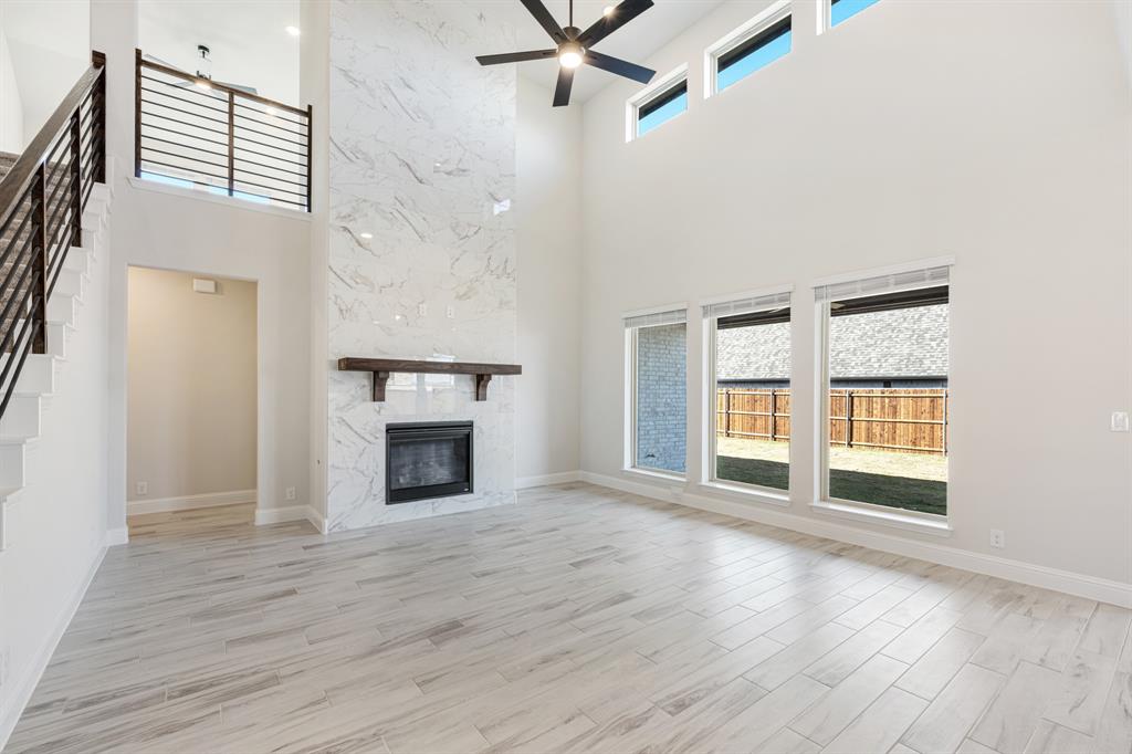 2411 Cornwall Lane Forney, TX 75126 - Photo 10 of 40 an empty room with windows and fireplace