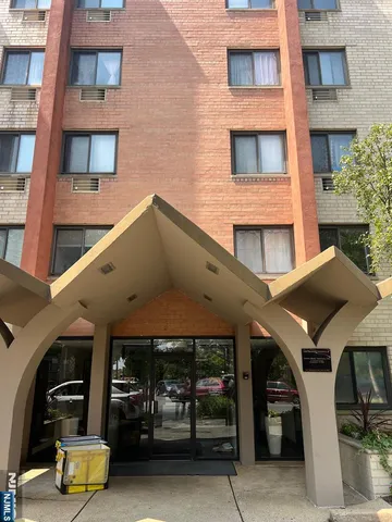 a front view of a building with parking