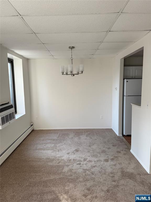 77 Prospect Avenue, Unit 1A Hackensack, NJ 07601 - Photo 4 of 10 an empty room with chandelier fan and windows