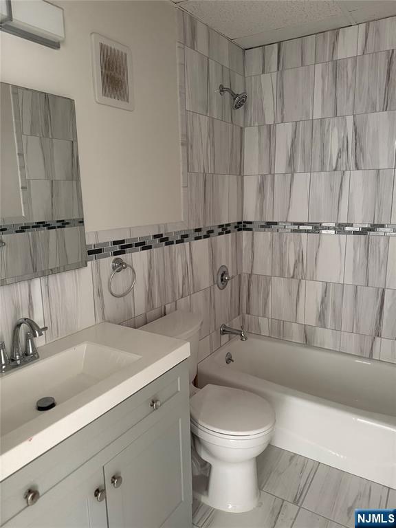 77 Prospect Avenue, Unit 1A Hackensack, NJ 07601 - Photo 8 of 10 a bathroom with a sink a toilet and bathtub