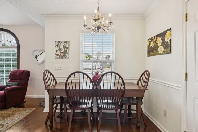 a view of a dining room with furniture and window
