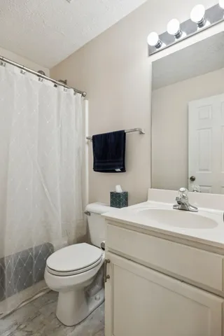 a bedroom with a bed and a lamp