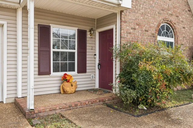 a view of a brick house with potted plants