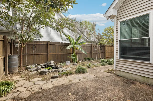 a view of a chair and table in backyard