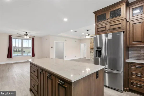 a kitchen with stainless steel appliances granite countertop a sink a stove and a refrigerator
