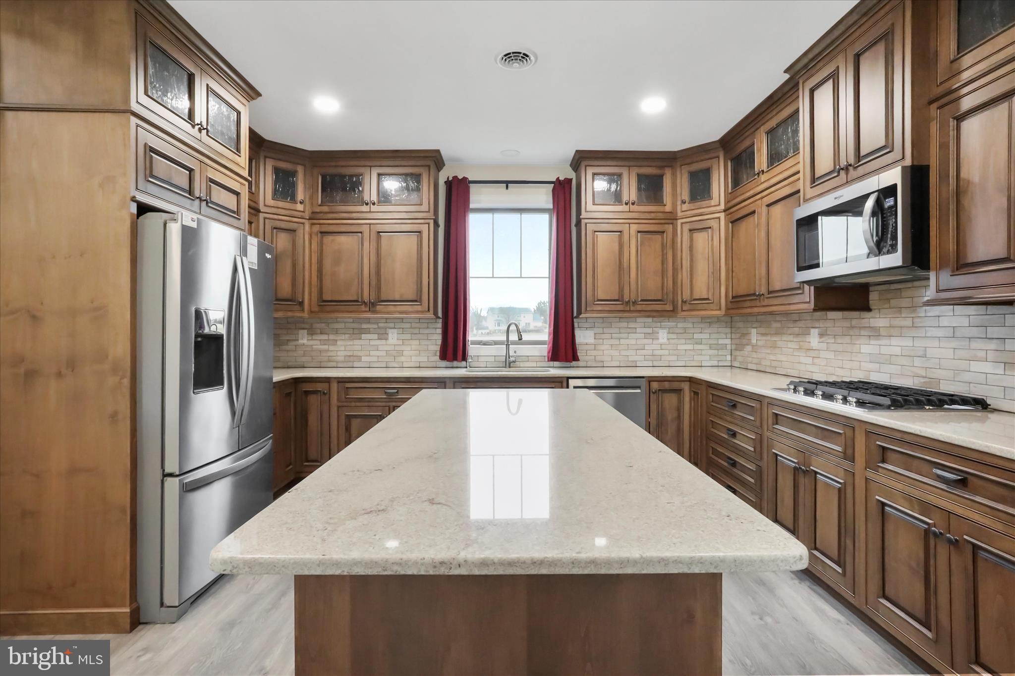 41 Smith Circle Littlestown, PA 17340 - Photo 12 of 53 a kitchen with stainless steel appliances granite countertop a sink a stove and a refrigerator