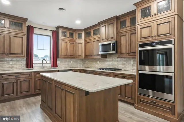a kitchen that has a sink and a stove