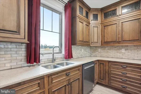a kitchen that has a sink and a stove