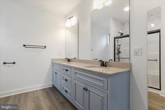 a bathroom with a double vanity sink and mirror