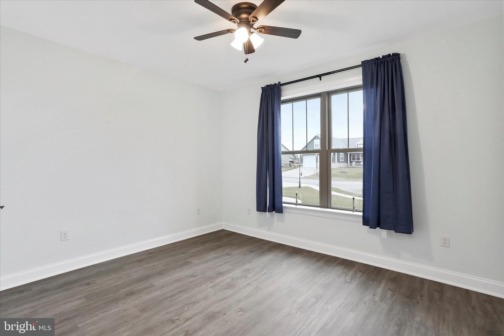 41 Smith Circle Littlestown, PA 17340 - Photo 23 of 53 an empty room with wooden floor fan and windows