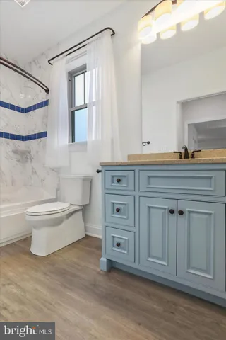 a bathroom with a toilet a sink and bathtub